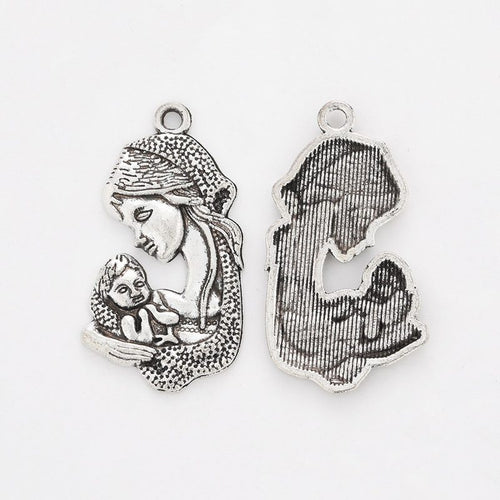 Close front and reverse view of the metal mother-and-child charm