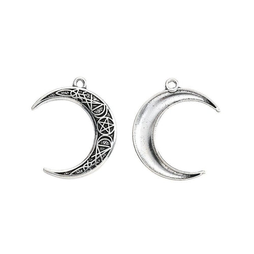 Close view of the patterned crescent moon charm surface and relief