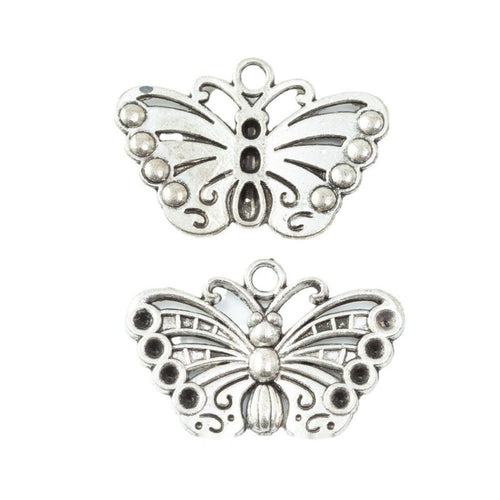 Assorted filigree butterfly finishes arranged on a white background