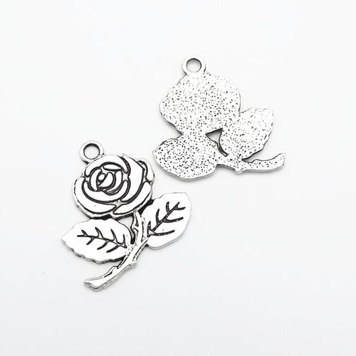 Antique Bronze, Antique Silver rose flower charm shown in a detailed product view