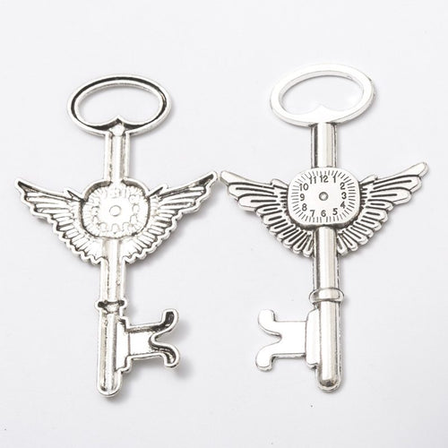 Close-up view of the winged gear skeleton key keychains in three finishes showing its front and reverse metal details.
