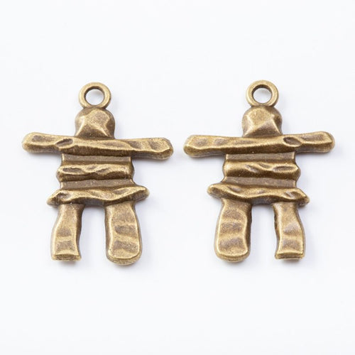 Close view showing the front and reverse details of the stacked stone figure charm