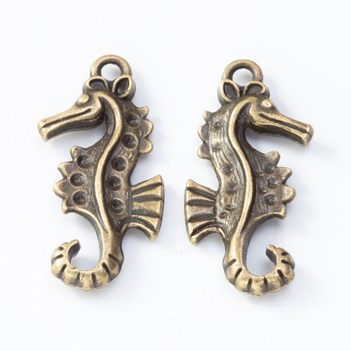Front and reverse details of seahorse charms on a white background
