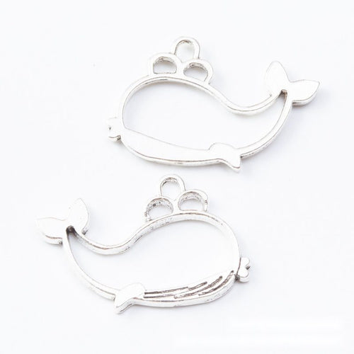 Close view of the relief and openwork details on the open whale resin frame charm
