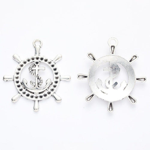 Ship Wheel and Anchor Metal Charm Pendants shown in a angled detail view on a plain background