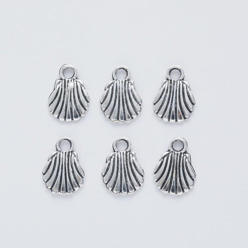 Scallop Shell metal piece showing front-facing surface and relief detail
