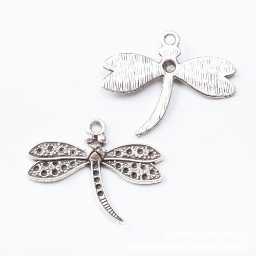 Close front view showing the shape and recessed details of the textured dragonfly charms