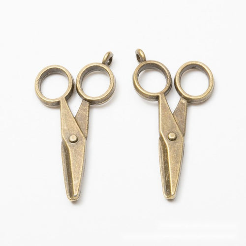 Scissors metal component, reverse and front details on a white background.
