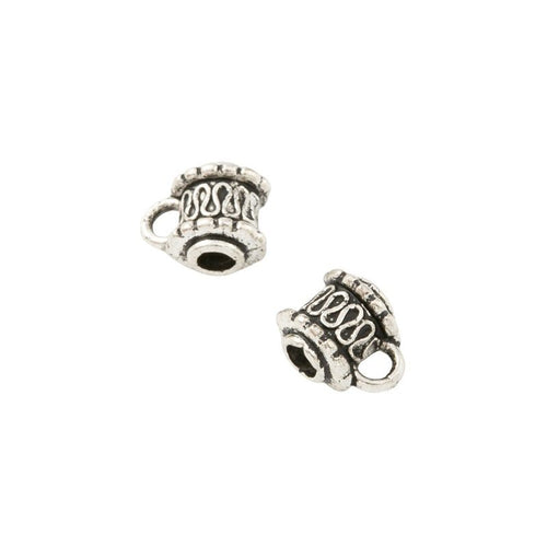 Barrel-shaped large-hole bead with scrolling relief and a hanging loop shown in front detail view