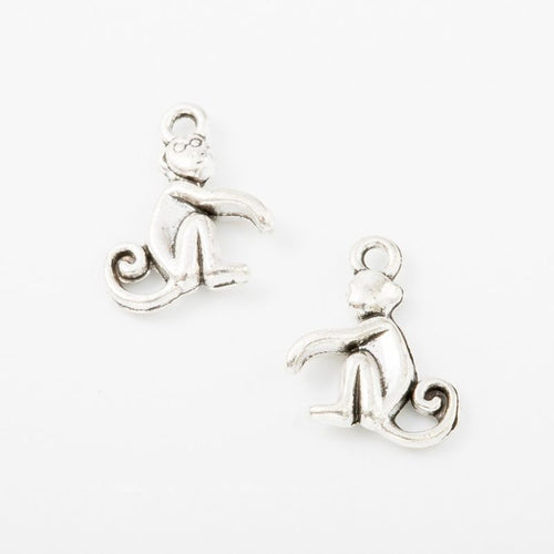 Close view of the front details on seated monkey charm pendants