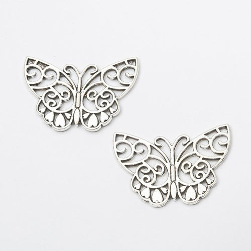 Close view of the front details on filigree butterfly charm pendants