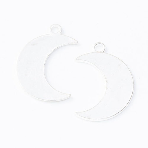 Close view of the crescent moon charm showing its raised front pattern