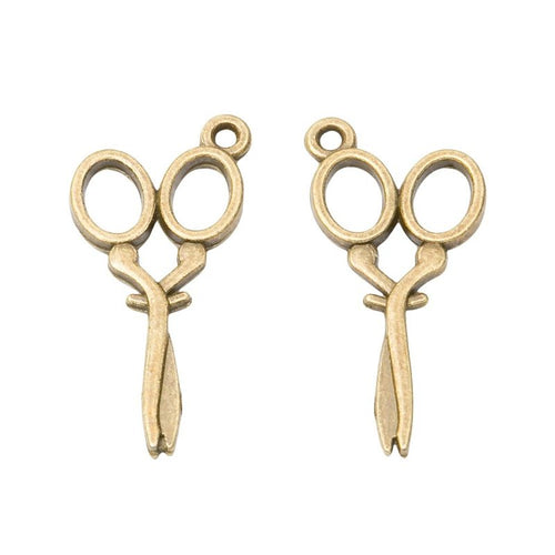 Close view showing the front and reverse details of the scissors charm