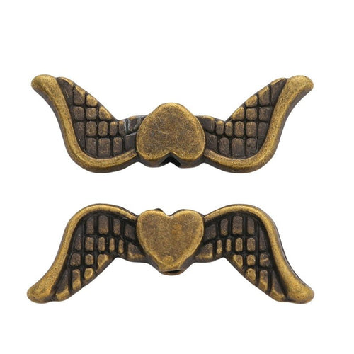 Detail view of heart-wing spacer bead showing finish variation 2