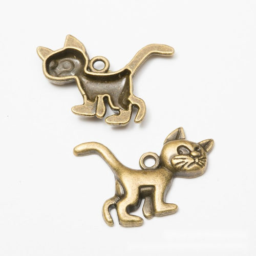 Close product view of the walking cat pendant charm in two antique metal finishes