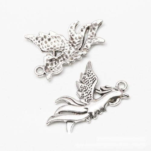 Phoenix Bird Charm Pendant front detail showing spread wings, a crested head, and flowing tail feathers