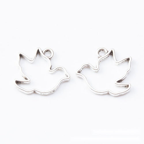 Closer product view of open bird silhouette bezel charm shown against a plain background.