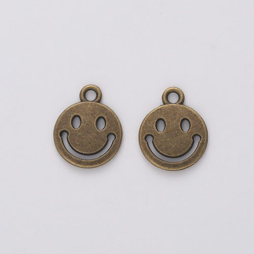 Close view of the round smiley face charm surface and relief