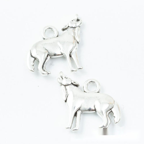 Close front view showing the shape and recessed details of the standing goat charms