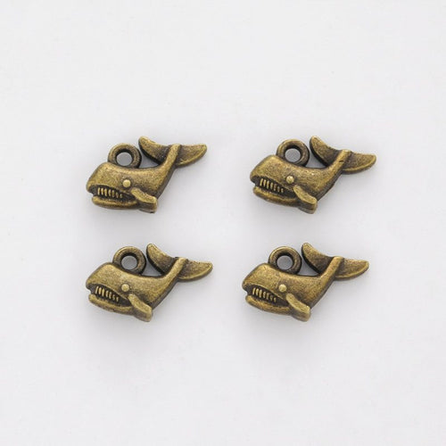 Front and reverse views of the tiny whale charm