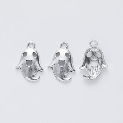Close view of the relief and openwork details on the smiling ghost metal charm