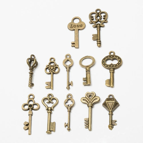 Front and reverse details of mixed ornate key charms on a white background