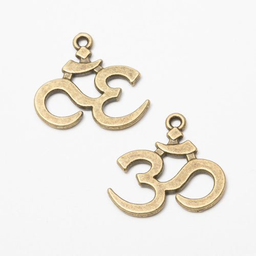 Close view of the Om symbol charm surface and relief