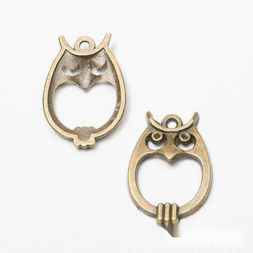 Close product view of the owl shaped open center connector in two antique finishes
