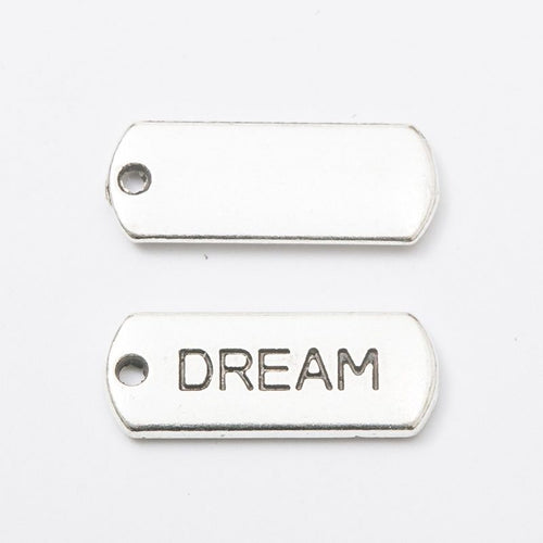 Close view of the relief and openwork details on the dream rectangular message tag charm