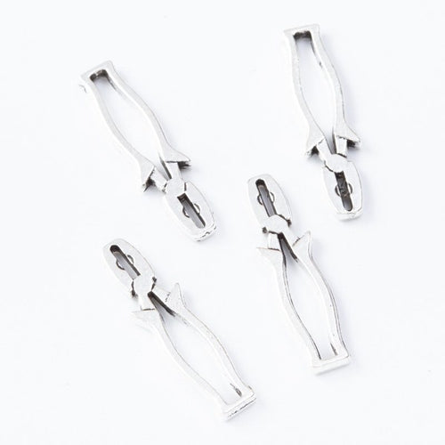 Close view of the pliers charm showing its raised front pattern