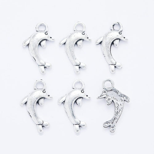 Leaping Dolphin metal piece showing front-facing surface and relief detail