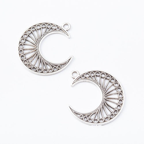 Filigree Crescent Moon Charm shown from the front in contrasting finishes