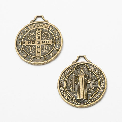 Close view showing the front details of the Saint Benedict medal charms