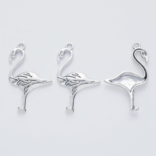 Close front view showing the shape and recessed details of the standing crane bird charms