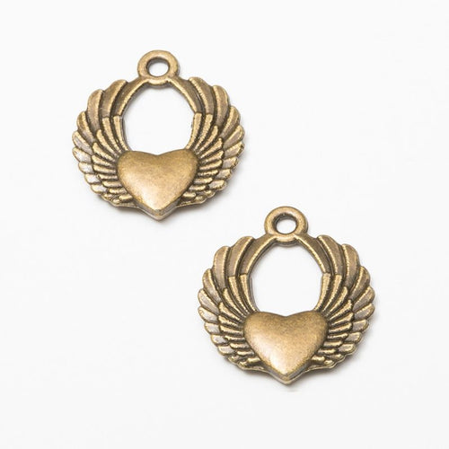 Product photo 2 of the winged heart wreath charm highlighting its central heart framed by feathered wings and a round op