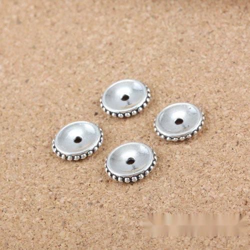 Front detail view of one pictured finish of round saucer spacer beads