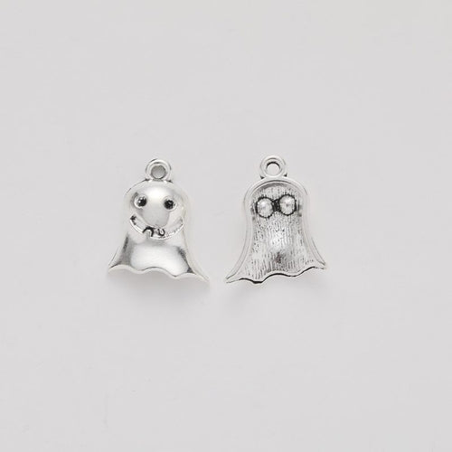 Close view of the relief and openwork details on the small smiling ghost metal charm