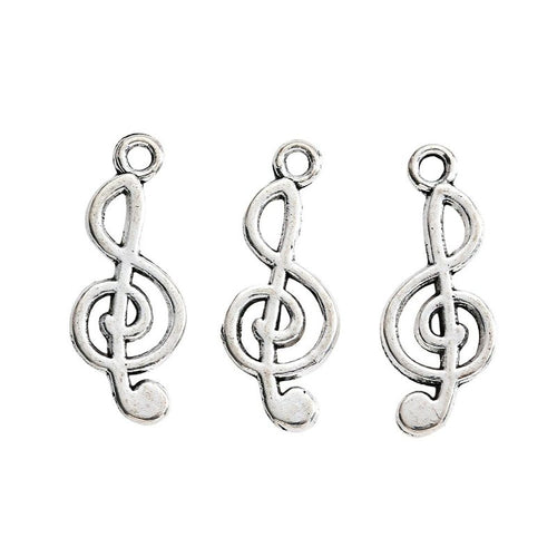 Close view showing the front and reverse details of the treble clef charm