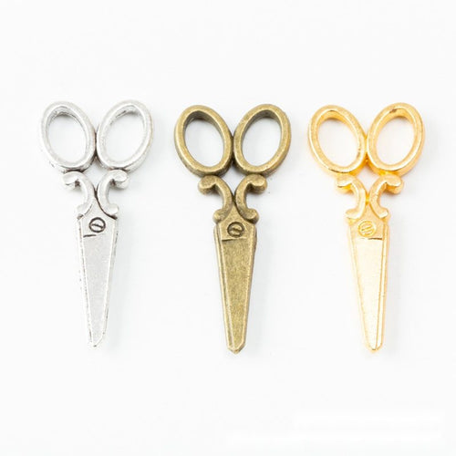 Close front view of scissors charm showing outlined handles and slim blades