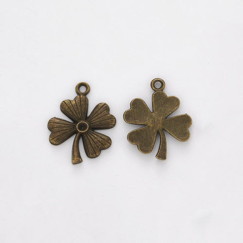 Front and reverse views of the rounded four leaf clover charm