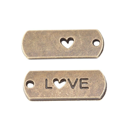 Close view showing the front and reverse details of the love heart cutout tag charm