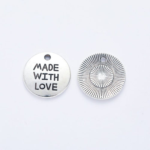 Front detail of made with love round metal charm