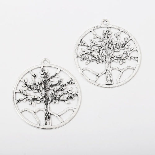 Close view showing the front and reverse details of the large round tree charm
