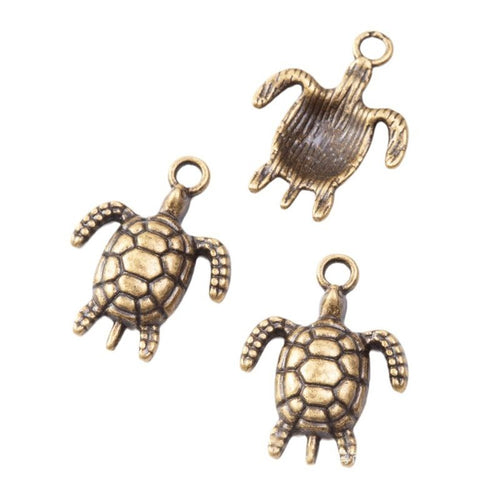 Small sea turtle charms with lattice-patterned open shells shown from the front on a white background.