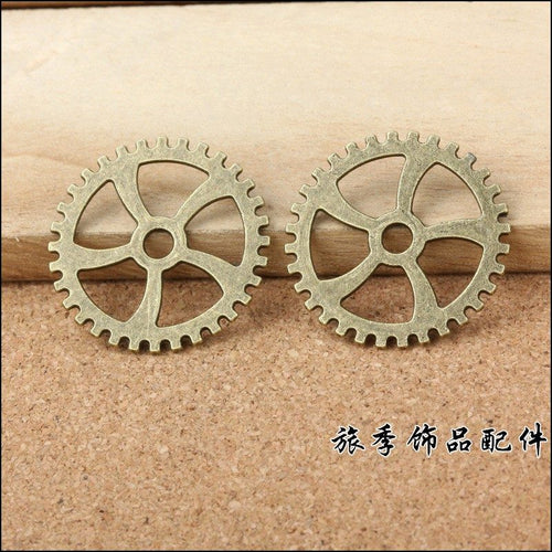 Five Spoke Gear Metal Charms close product view showing form and surface detail