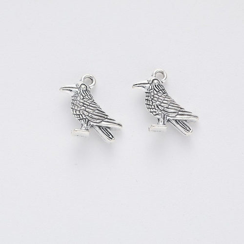 Closer product view of perched raven charm shown against a plain background.