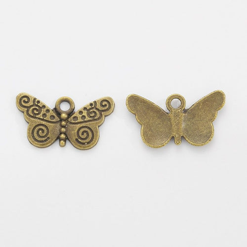 Close view showing the front and reverse details of the scrollwork butterfly charm