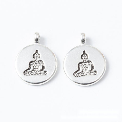 Front and reverse views of the round seated yoga figure metal charms in two finishes