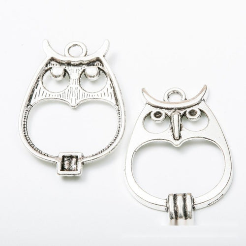 Close view of the owl charm showing its raised front pattern