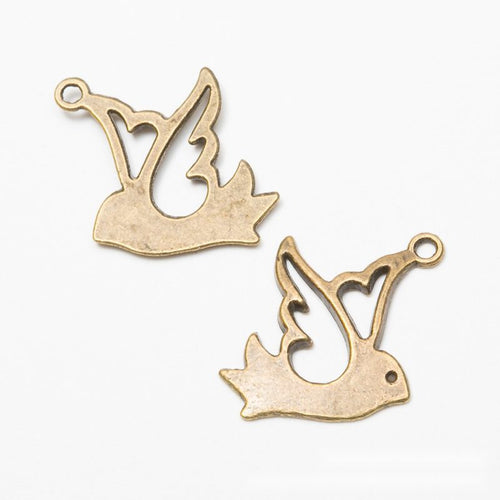Close product view of the flying bird silhouette charm in two antique finishes